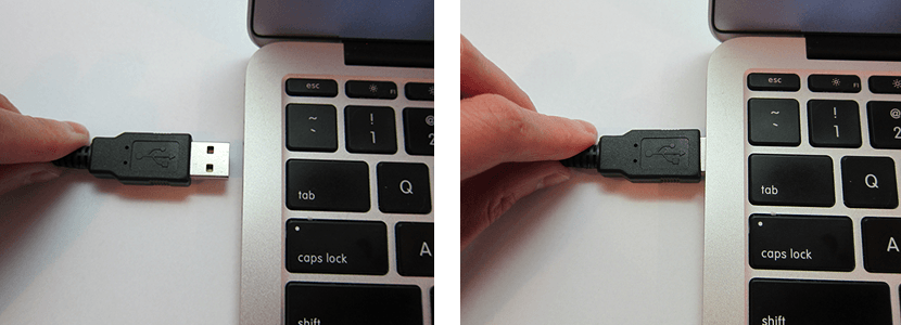 USB cable being plugged into laptop