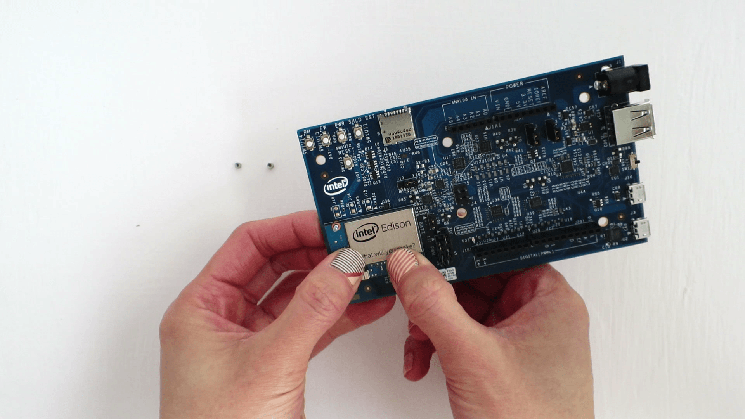 Press down on the Intel® Edison compute module until you feel a snap